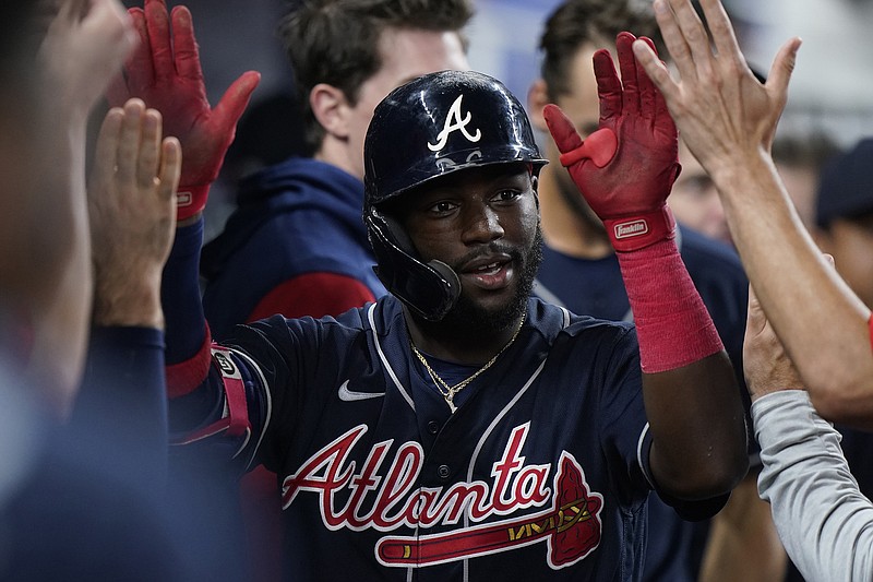 AP photo by Wilfredo Lee / Atlanta Braves center fielder Michael Harris II is congratulated by teammates after he hit a tying home run to lead off the ninth inning of Sunday's 3-1 road win against the Miami Marlins.