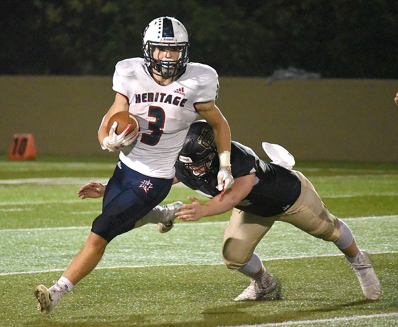 Staff Photo by Matt Hamilton / Heritage (3) Paxton McCrary looks for running room as Christian Heritage (54) Ben Williamson comes at him from behind. Christian Heritage went on to defeat Heritage High School 39-7 in Dalton on Friday Sept. 25, 2020. 