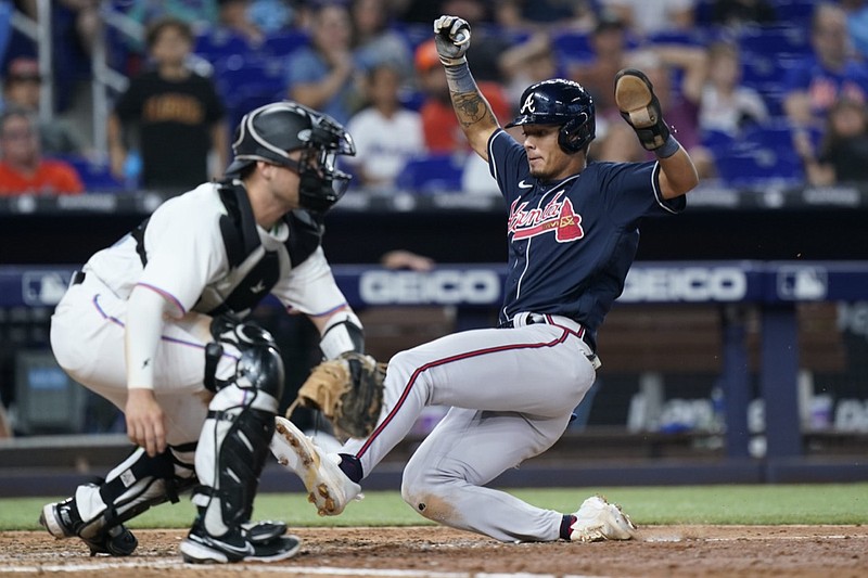 Atlanta Braves' Vaughn Grissom, right, slides in to score as Miami Marlins catcher Nick Fortes waits for the throw during the ninth inning of a baseball game, Sunday, Aug. 14, 2022, in Miami. (AP Photo/Wilfredo Lee)



