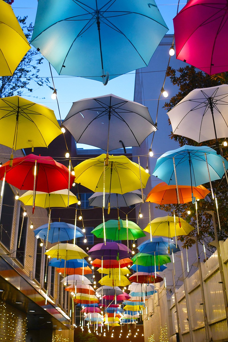 Umbrella Alley, off Chestnut Street, in the West Village glows before sunrise on August 16, 2022. The whimsical display is one of the many features of the redesigned area that has become a magnet for tourism. /  Staff Photo by Robin Rudd

