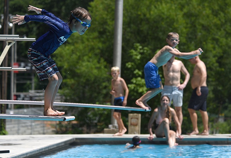 Staff photo by Matt Hamilton / Classmates Arthur Allison, left, and Bryce Ayres, both 7, jump into the water at the Signal Mountain pool on Tuesday, August 9, 2022. Tuesday was the last day for the pool's weekday summer hours as the fall school year began the next day. While the pool has been opening at 11 a.m. during the summer, it will now open at 4 p.m. on weekdays through Labor Day weekend.
