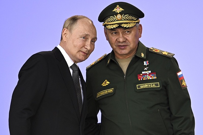Russia's President Vladimir Putin and Russian Defense Minister Sergei Shoigu attend the opening of the Army 2022 International Military and Technical Forum in the Patriot Park outside Moscow, Russia, Monday, Aug. 15, 2022. Putin vowed to strengthen Russia's military cooperation with its allies. (Sputnik, Kremlin Pool Photo via AP)